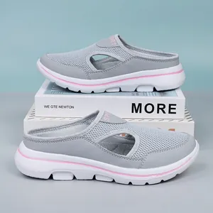 Comfortable grey breathable mesh slip-on mules with pink accents on thick white soles