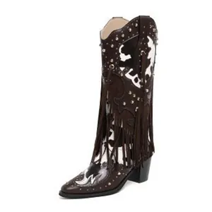 Detailed view of stylish western cowboy boots for women featuring fringe and cow print.