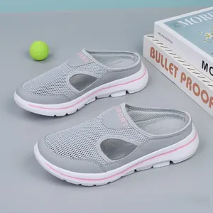 Detailed macro view showing breathable mesh texture of grey slip-on mules with pink accents