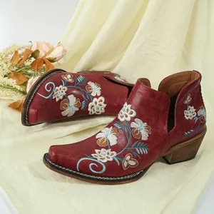 Vintage red embroidered Western ankle boots with floral patterns, side cutout, and chunky heel