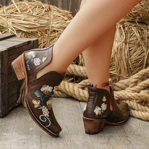 Close-up of retro western embroidered square toe ankle boots with block heel