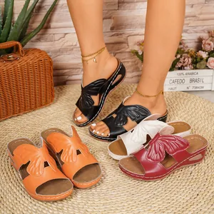 Detailed view of women's butterfly wing wedge sandals in multiple vibrant colors