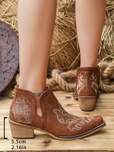 Close-up of brown western ankle boots with floral embroidery and 5.5cm block heel