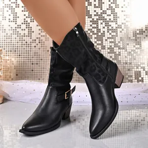 Detail view of black western cowboy boots featuring leopard print and ankle buckle