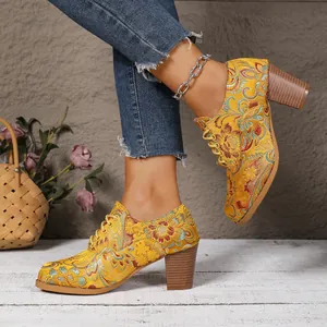 Detailed view of yellow vintage floral embroidered chunky heel lace-up shoes for women