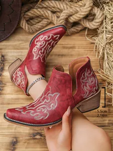 Detailed view of red vintage ankle boots with 5.5cm chunky heel and embroidery.