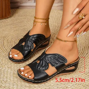 Close-up of butterfly wing wedge sandals showing the 5.5cm/2.17in heel height.