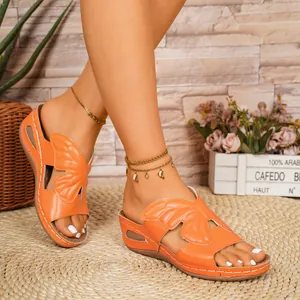 Macro view showing the intricate orange butterfly wing design on these summer sandals
