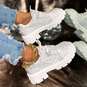 Close-up of white platform sneakers covered in sparkling rhinestones