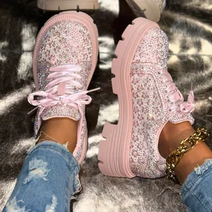 Close-up of pink platform casual shoes covered in sparkling rhinestones.