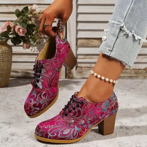Detailed view of retro embroidered satin high heels with chunky wooden-style heels