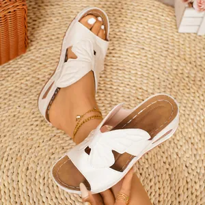 Detailed macro view of white butterfly wedge sandals with comfortable air cushion soles