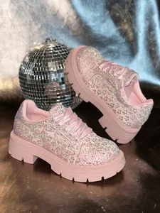 Detail macro view of the sparkling rhinestone embellishments on pink platform sneakers