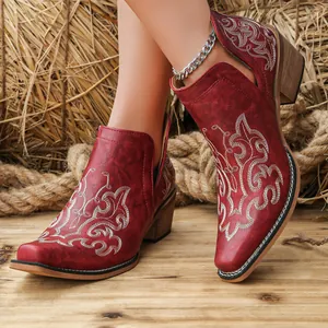 Western style red floral embroidered ankle boots featuring chunky heels and rustic design