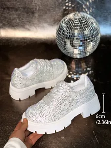 Detailed view of the 6cm platform sole on these sparkly rhinestone encrusted white sneakers