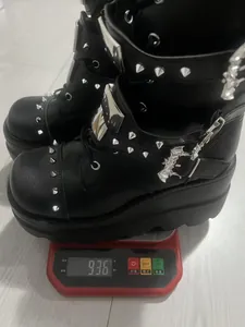 Detail shot of black gothic platform boots with studs weighing 936 grams on scale