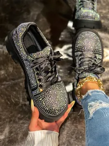 Close-up detail of luxury rhinestone-covered platform shoes with elegant satin laces