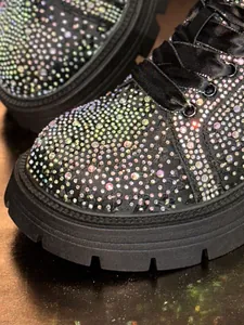 Detailed macro view of sparkling colorful rhinestones on stylish black platform shoe