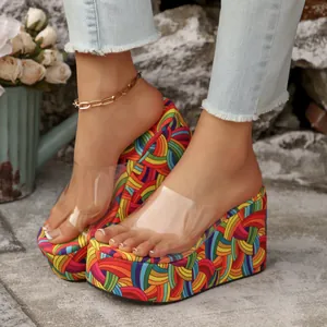 Detail view of colorful rainbow pattern wedge sandals with clear PVC strap