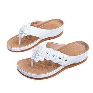 Comfortable white wedge thong sandals with decorative flowers and gold studs