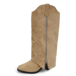 Detailed side view of tan suede western knee-high boots with elegant embroidery and zipper