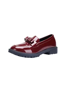 Detail of vintage style burgundy patent leather loafer with elegant bow decoration