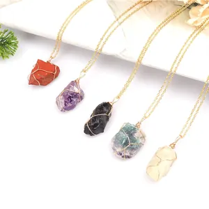 Close-up of handmade wire wrapped natural raw crystal stone necklaces in various colors