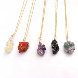 Detail of five natural raw crystal necklaces with handmade gold wire-wrapped pendants