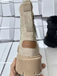 Dettaglio del tallone di uno stivale da neve beige con logo e suola