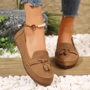 Close-up view of brown women's tassel loafers featuring soft vintage leather texture