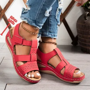 Red platform wedge sandals with 5.5cm heel height and decorative hollow-out details
