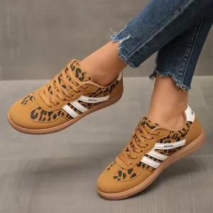 Close-up detail of women's leopard print German trainer sneakers with iconic white stripes