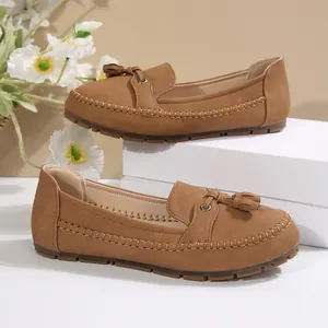 Detail view of brown suede tassel loafers for women with soft rubber soles