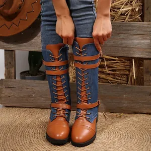 Detail of women's denim and leather patchwork knight boots with lace-up straps.