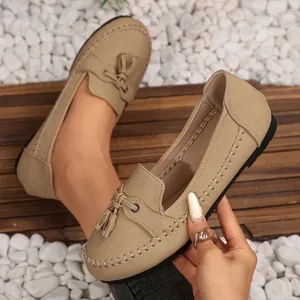 Beige women's stitched flat loafers with tassel detail, soft slip-on walking shoes