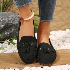 Detail of black women's tassel moccasins with soft soles for casual spring wear