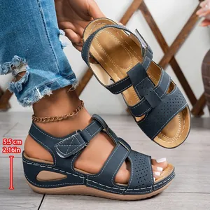 Navy blue platform wedge sandals with cross-stitch and laser-cut details for women.
