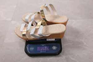 Weight measurement of gold and silver glitter wedge sandals, showing 353.4g on scale