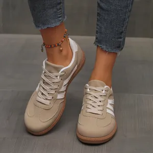 Detailed view of women's retro khaki suede German Army Trainers sneakers on feet