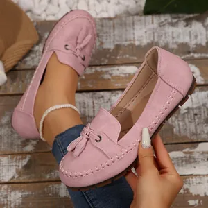 Detailed view of pink suede tassel loafers for women featuring soft soles and slip-on design