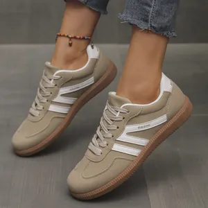 Close-up of retro khaki suede German Army Trainers with white M-shaped stripes