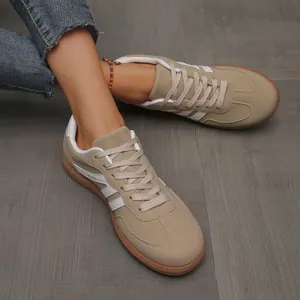 Close-up of khaki retro German Army Trainers featuring white stripes and a gum rubber sole