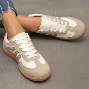 Close-up of retro German Army Trainer style sneakers with beige suede and leather details.