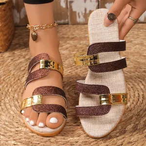 Detailed view of the brown glitter and metallic gold straps on these summer sandals