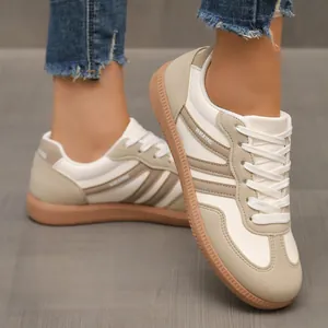 On-feet detail view of retro white and beige German Army Trainers with gum soles