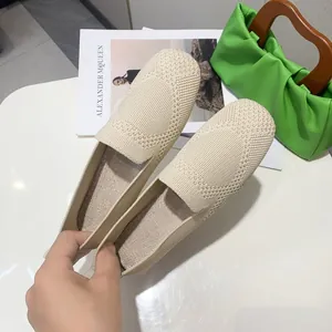 Close-up of beige woven flat shoes with breathable knit texture and square toe
