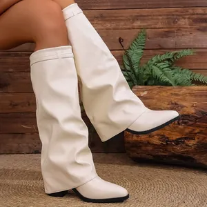 Close-up of stylish cream knee-high boots featuring a unique pant leg slouchy overlay design