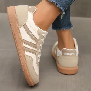 Detailed view of women's retro patchwork German army trainers sneakers with WALKING detail