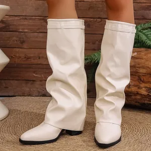 Detailed macro shot of off-white slouchy knee-high boots with a trendy pointed toe design