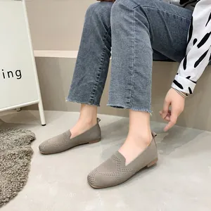 Detailed view of women's breathable knitted square-toe flat shoes on a model's feet